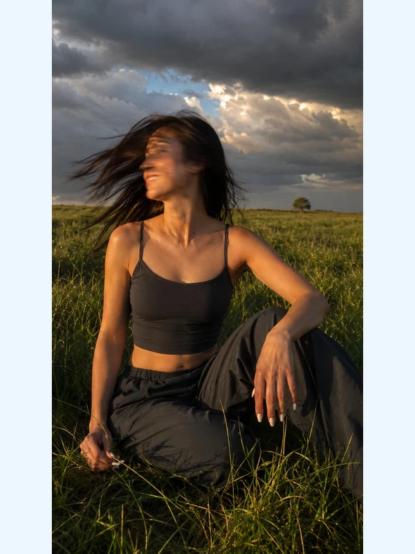Intentional motion-blur fashion portrait in a sunset meadow